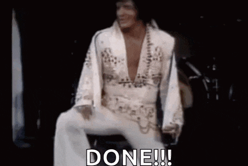 elvis presley is sitting on a chair with his legs crossed and the words `` done '' written on the screen .