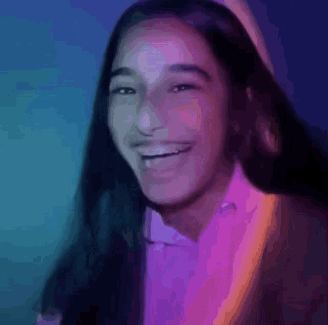 a close up of a woman 's face with a purple and blue background