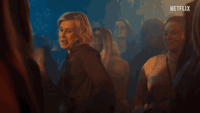 a group of people are dancing in a dark room with the word netflix on the bottom