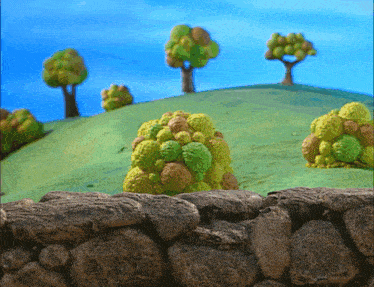 a cartoon landscape with a stone wall and trees on a hill