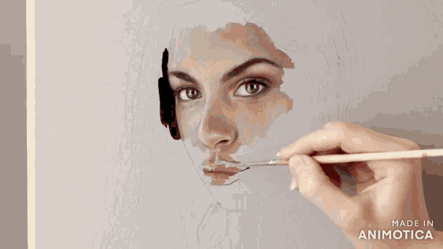 a person is painting a woman 's face on a canvas with the words made in animotica below it