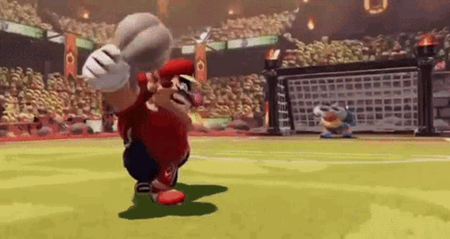 mario is playing a game of soccer on a soccer field .