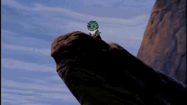 a pixel art drawing of a dinosaur sitting on top of a rock