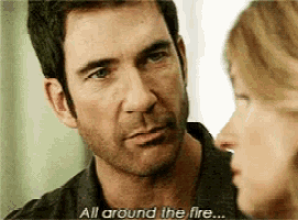 a man and woman are looking at each other and the man says all around the fire