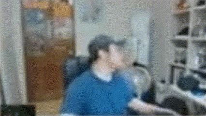 a blurry picture of a man wearing a baseball cap and a blue shirt .