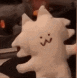 a close up of a stuffed animal with a face on it .