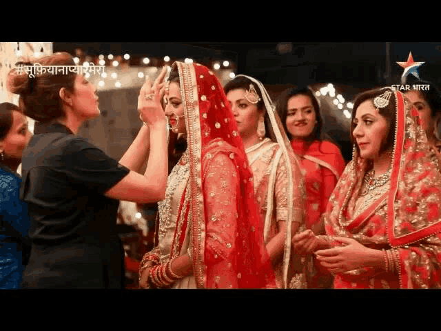 a bride is getting her makeup done by a woman with a star india logo in the background