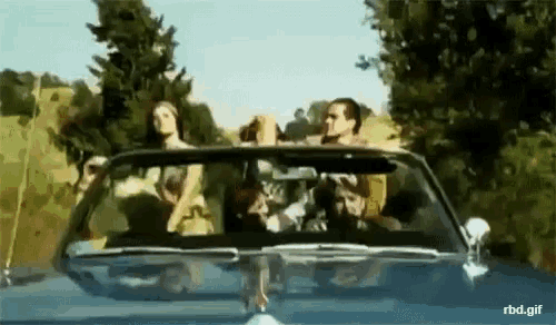 a group of people are riding in a convertible car with a watermark that reads rbd.gif