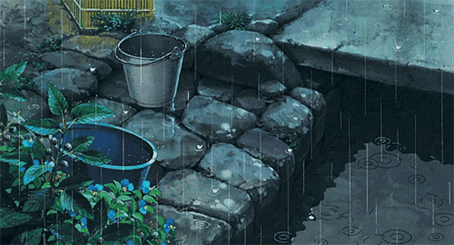 a bucket sits on a stone wall next to a pond