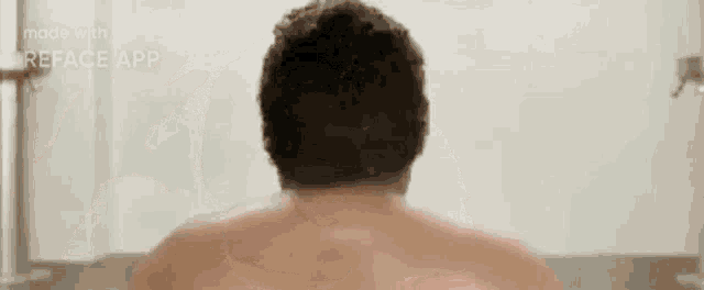 a man is taking a bath without a shirt on in a bathtub .