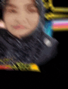 a blurry picture of a woman 's face with a rainbow background