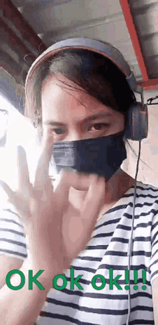 a woman wearing a mask and headphones says ok ok ok