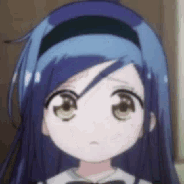 a close up of a person 's face with blue hair and brown eyes .