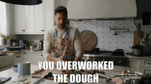 a man in an apron is standing in a kitchen with the words you overworked the dough above him