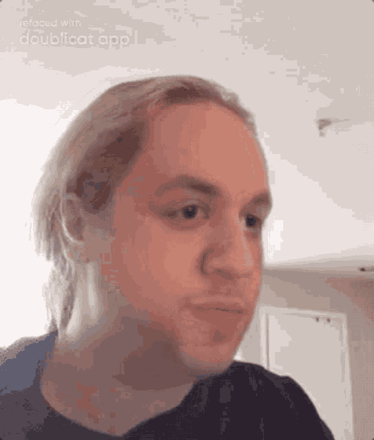 a man with blonde hair is making a funny face with doublecat app .