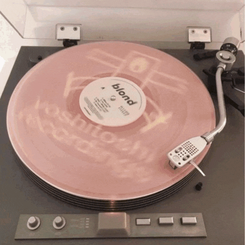 a record player is playing a pink blond record