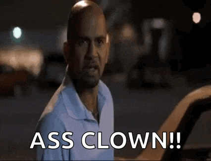 a bald man in a blue shirt is standing next to a car and says `` ass clown '' .