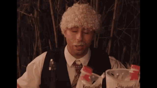a man wearing a white wig and a mustache is holding a bottle of kentucky ice cream