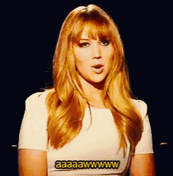a woman with red hair is wearing a white shirt that says aaaaawww