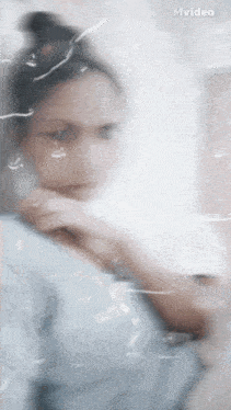 a blurry picture of a woman behind a glass with mvideo written on it