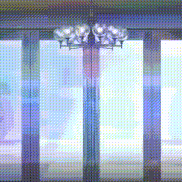 a chandelier is hanging from the ceiling in front of a window .