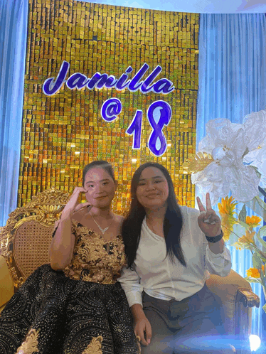 two girls posing in front of a wall that says jamila @ 18