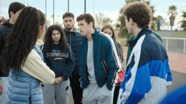 a group of young people are standing in a circle with one wearing a sweatshirt that says sydney