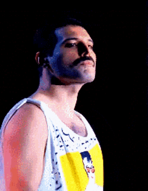 a man with a mustache is wearing a white tank top and a yellow shirt