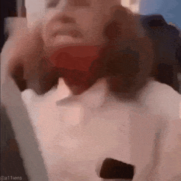 a close up of a person 's face with a red bandage on their face .