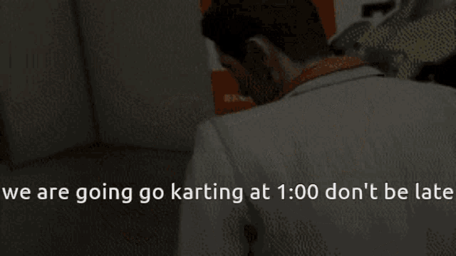 a man is holding a toy car with the words we are going go karting at 1:00 don 't be late