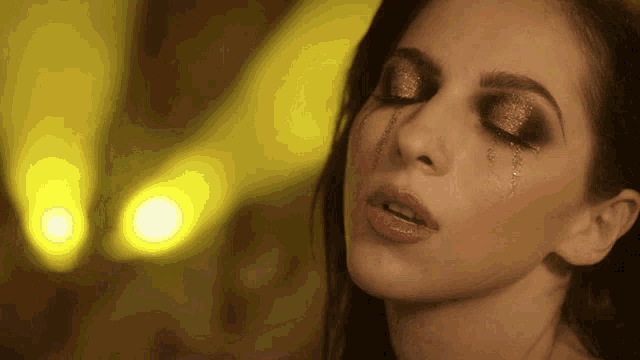 a close up of a woman with tears running down her face