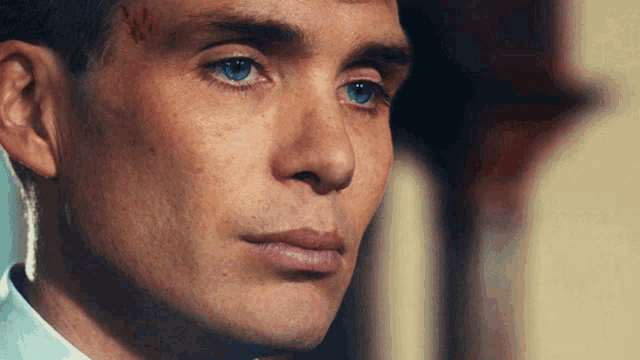 a close up of a man 's face with his eyes closed