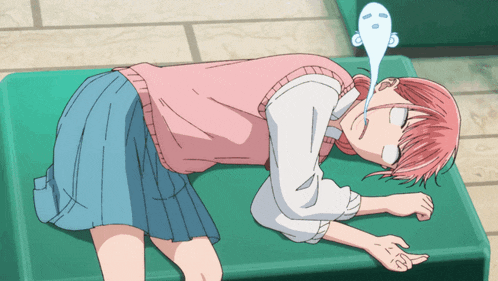 a girl in a pink vest and blue skirt is laying on the floor