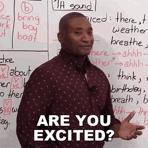 a man standing in front of a white board with the words are you excited written on it