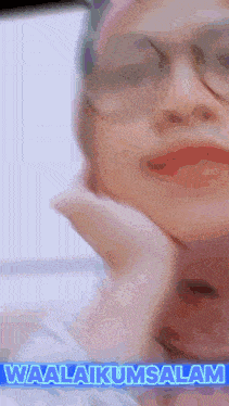 a close up of a woman 's face with the words waalaikumsalam written above her