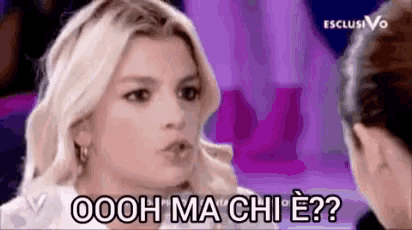 a blonde woman is talking to another woman and says ooh ma chi e