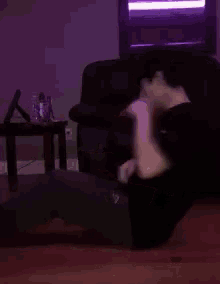 a man sitting on the floor looking at his phone