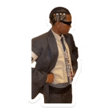 a man in a suit and tie is wearing sunglasses and holding his jacket .