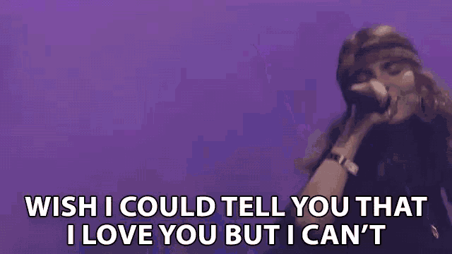 a woman singing into a microphone with the words wish i could tell you that i love you but i can 't .