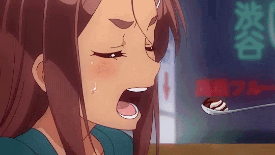 a girl with her mouth open looking at a spoon of food with chinese writing behind her