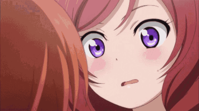 a girl with purple eyes looks at another girl with red hair