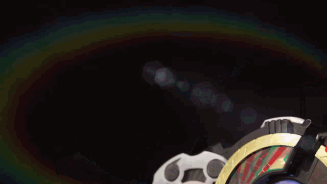 a close up of a toy that has a rainbow in the background