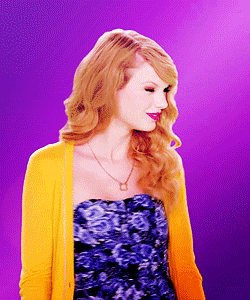 a woman wearing a yellow cardigan and a strapless blue dress