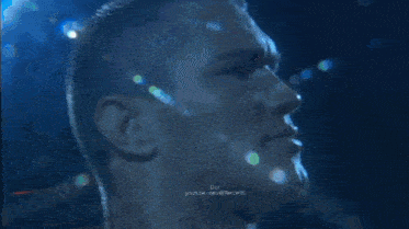 a shirtless man stands in a boxing ring with the words do on the bottom left