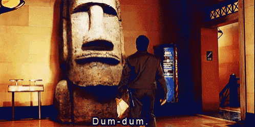 a man standing in front of a statue with the words dum-dum written on it