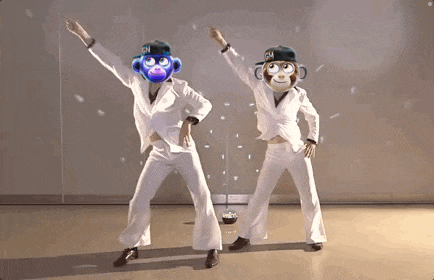a couple of people with monkey faces on their heads are dancing