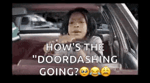 a woman is sitting in a car and looking out the window .