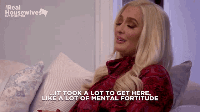 a blonde woman is sitting on a couch with the words " it took a lot to get here like a lot of mental fortitude "