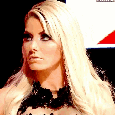 a woman with blonde hair and a nose ring is wearing a black lace top .