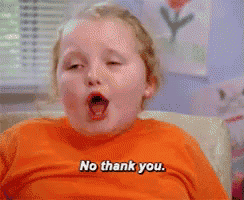 a little girl says no thank you while eating something